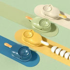 Three colorful garlic presses in white, green, and yellow with minced garlic cloves
